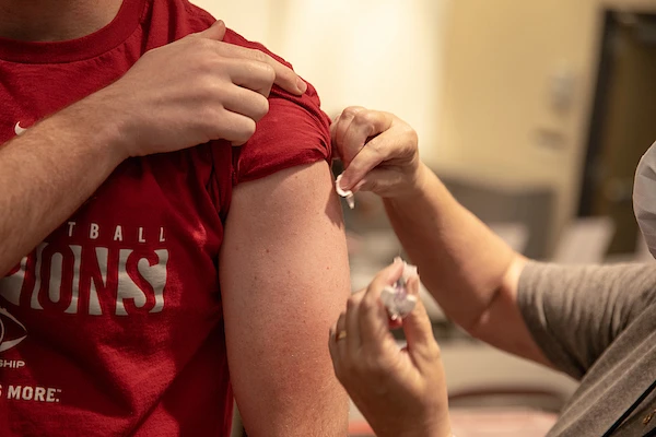 student getting a shot in the arm